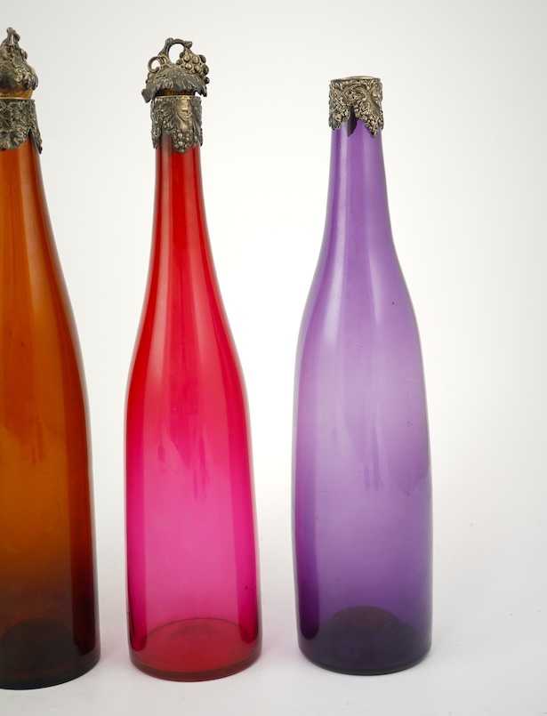 A composed set of six mid 19th century vari-coloured glass carafes